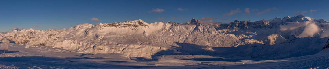 The setting sun illuminates the alpine panorama