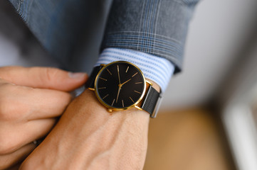 black watch, shirt, jacket. wrist shot