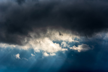 Fototapeta na wymiar Dark clouds and sun rays