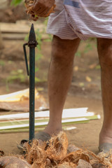 Man open coconut shell by old knife