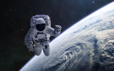 Astronaut on background of the Earth. Solar system. Science fiction. Elements of this image furnished by NASA