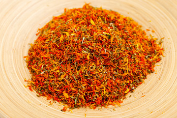 Dried marigold flowers on a bamboo plate. Apothecary