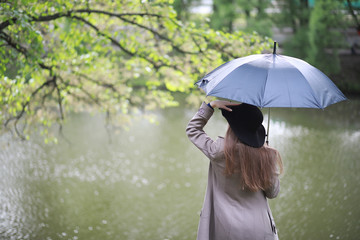 Young girl in a coat in a spring park