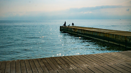 Fototapeta na wymiar wooden promenade with a pier on a warm autumn day