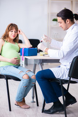 Young pregnant woman in blood transfusion concept
