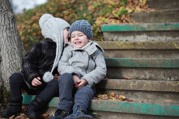 Children walk in the autumn park