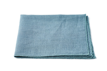 Single turquoise textile napkin on white background