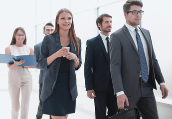 business people going along the office corridor during working day