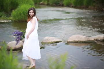 Pregnant woman in nature for a walk in the summer