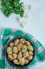 Fried breaded cauliflower. Dish in a small pan. White wood background. Space for text.