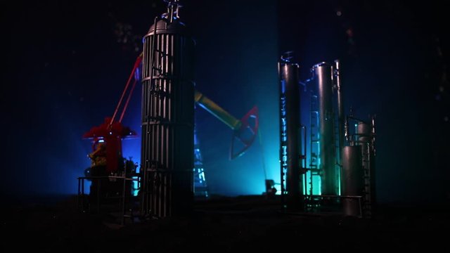 Oil pump and oil refining factory at night with fog and backlight. Energy industrial concept. Selective focus. Artwork decoration.
