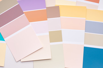 Color palette with various samples. Light background. Paint selection cards, close-up.