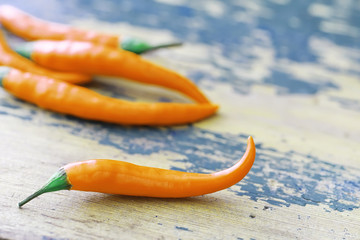 Hot orange pepper. Chilean pepper on a black.