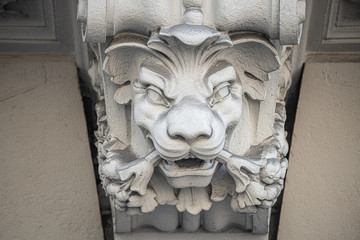 Statue of powerful and emotional head of a lion as support for building facade in Vienna, Austria