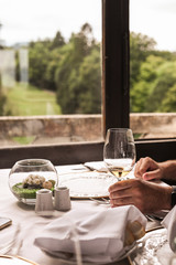 Glass of wine on the table by the window. Interior of a classic restaurant in an old castle. Traveling in Europe. Served tables and antiquity.