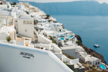 Reception sign on a wall in Santorini island. Reception pointer with arrow.