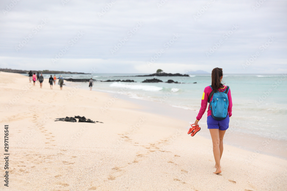 Wall mural galapagos islands - woman on cruise ship tour visiting playa las bachas beach on santa cruz island. 