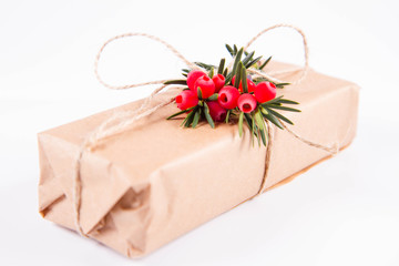 Gift decorated with a gunny string bow and with a common yew twig	