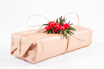 Gift decorated with a gunny string bow and with a common yew twig	