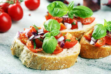 fresh tomato bruschetta. italian food appetizer with basil on table