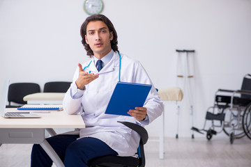 Young handsome doctor working in the clinic