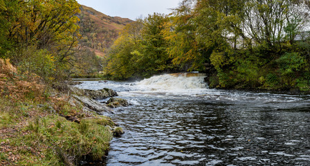 the powerfall waterfalls and overflow in the village of kinlochleven in the argyll region of the highlands of scotland during autumn
