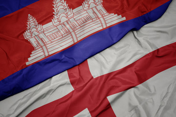 waving colorful flag of england and national flag of cambodia.