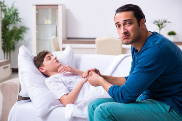 Young father caring for sick son