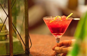 An alcoholic cosmopolitan cocktail is on the bar. Space for text. Photo for the menu