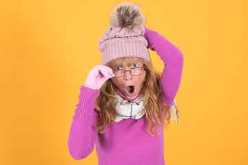 woman with warm clothes and glasses isolated on color background