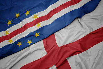 waving colorful flag of england and national flag of cape verde.