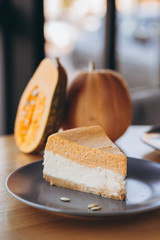 Slices of Freshly Baked Pumpkin Pie on cozy cafe background, selective focus, noise effect