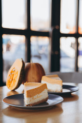 Piece of pumpkin homemade cake. Festive dessert concept. pumpkin tart on cozy cafe background, selective focus, noise effect