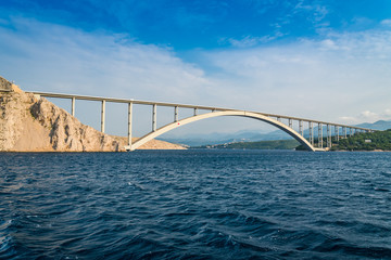 Bridge to the island Krk under blue sky on a sunny summer day. Krk is the big island of the Croatian coast of the Adriatic Sea. Travel landscape
