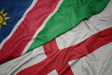 Fototapeta premium waving colorful flag of england and national flag of namibia.