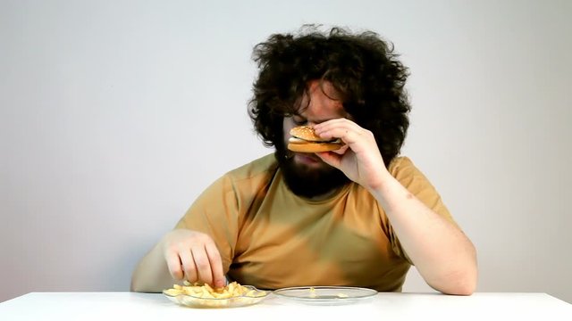 Very Hungry Obese Man Eating All The Hamburger 