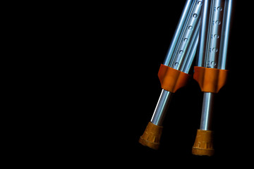 Crutches closeup isolated on a black background. The concept of the image 