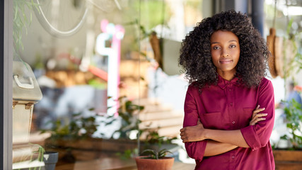 Young African American woman standing in front of her cafe