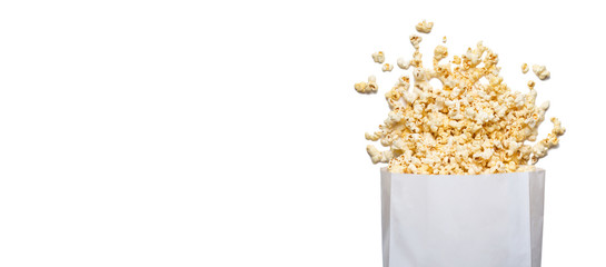 Fresh tasty salty popcorn with a box isolated on white background