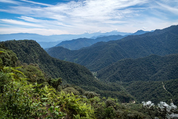 Amazing panoramic view of Bella Vista valley. You can see several mountains, hills, wild vegetation and the sky full of clouds. Mindo, Ecuador