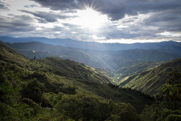 Panoramic view of the Ecuadorian sierra at sunset. There are big clouds, mountains, shrubs and...