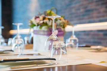 Luxury elegant table setting for dinner at a restaurant with flowers