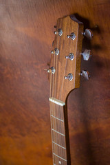 Guitar head close-up with tuning pegs. Detail of an acoustic guitar 