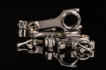Obraz na płótnie Canvas high performance racing motorcycle engine parts on a black reflective background