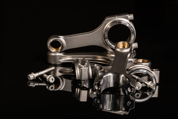 high performance racing motorcycle engine parts on a black reflective background