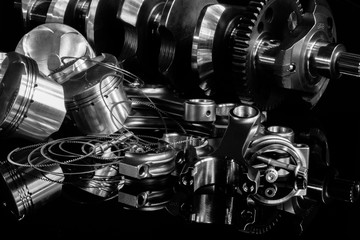 high performance racing motorcycle engine parts on a black reflective background