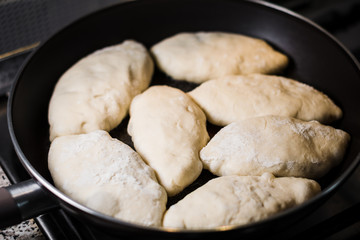 Frying fresh pies on a gas stove