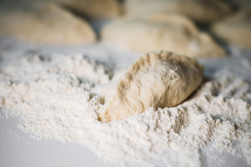 Blanks pie on a white table, flour, raw dough