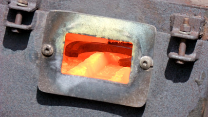 Horsshoe is heating up inside a farrier's forge.