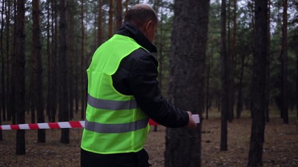 group of volunteers in green vests went in search of missing persons in a pine forest